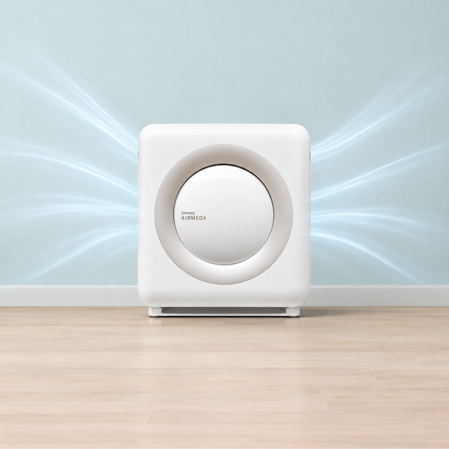 Only the cleanest air for your home sanctuary. A Coway air purifier in family room with dad in the kitchen making a bottle.