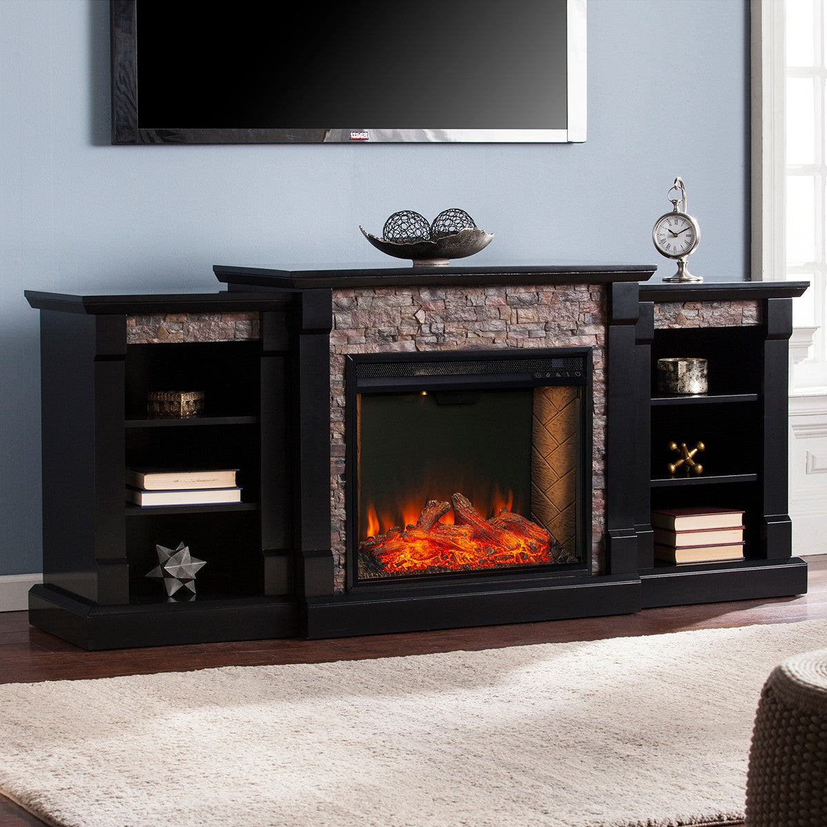 Southern Enterprises Gallatin Faux Stone Fireplace - against powder blue wall