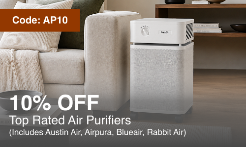 A white Austin Air air purifier standing next to a beige sofa in a living room setting, with promotional text overlays reading 'Code: AP10' and '10% OFF Top Rated Air Purifiers'.