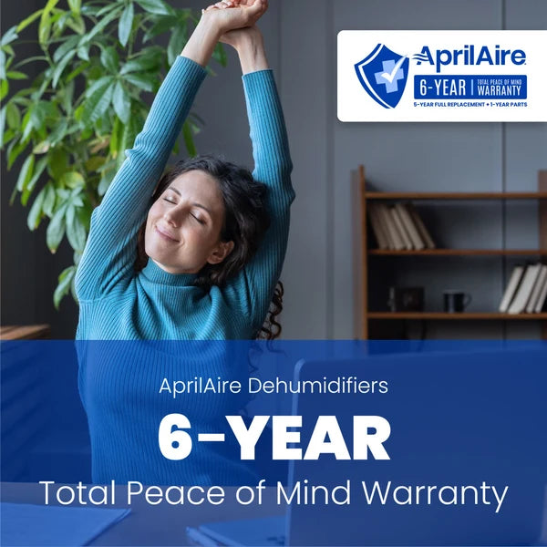 A promotional graphic for AprilAire dehumidifiers featuring a woman stretching in a home interior with a plant and bookshelf in the background. Large text reads 'AprilAire Dehumidifiers 6-YEAR Total Peace of Mind Warranty,' and the AprilAire logo appears in the top right.