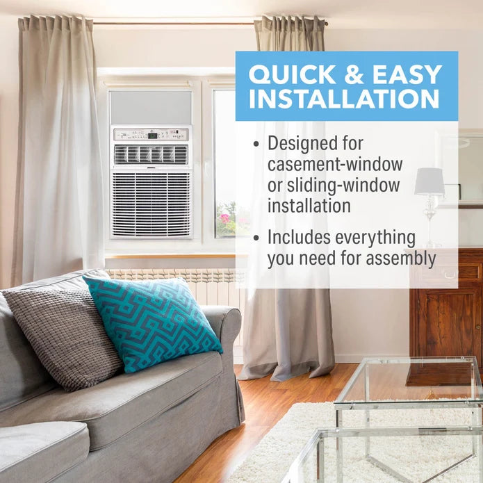 A Perfect Aire 10,000 BTU Casement Window Air Conditioner shown installed in a window inside a living room. The room has beige curtains, a gray sofa with patterned pillows, wood floors, and a glass coffee table. Quick and easy installation notes on a card.