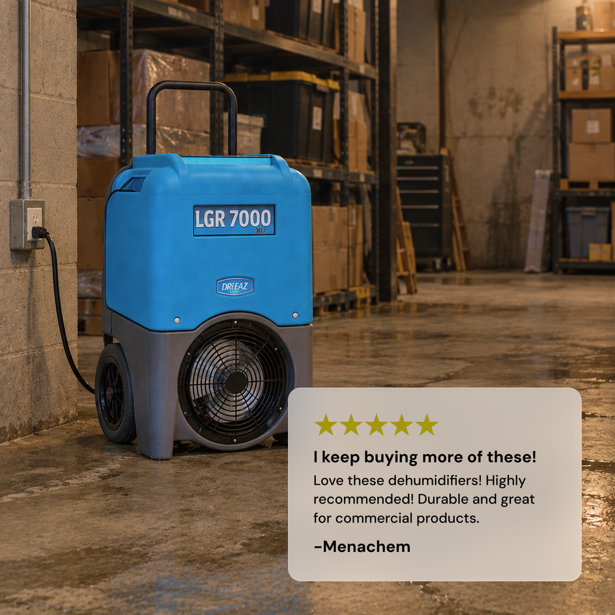 A blue and gray Dri-Eaz LGR 7000XLi commercial dehumidifier standing on a concrete warehouse floor next to a wall, with shelving in the background and a large customer 5 star review card overlaid in the lower right corner. "I keep buying more of these"