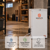 A white Santa Fe Class dehumidifier stands in a storage room with shelves and bins in the background. Three promotional text boxes at the bottom highlight strong moisture removal, energy efficient performance, and built-to-last construction.