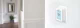 Honeywell Home T6 Pro Programmable Thermostat on a wall with a blurred room background