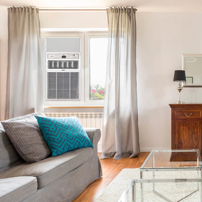 Living room with gray sofa, blue pillow, and Perfect Aire 10,000 BTU Casement Window Air Conditioner