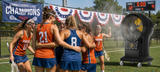 Big Ass Fans Torrent 30 in. 6874 CFM Portable Atomized Misting Fan cooling a group of female lacrosse players hugging on a field.
