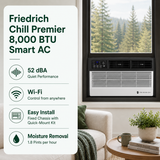 A Friedrich Chill Premier 8,000 BTU smart window air conditioner shown installed in a real room setting with a couch, table, plant, and window view of trees. A large feature callout on the left lists 52 dBA quiet performance, Wi-Fi control, easy installation, and moisture removal.