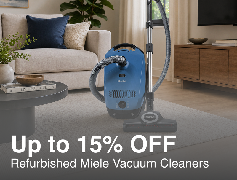 A blue Miele vacuum cleaner with a gray hose stands on a light gray rug in a modern living room. A sofa, side table, plant, and wood cabinet are visible in the background. Marketing text for 15% off Refurbished Miele Vacuums