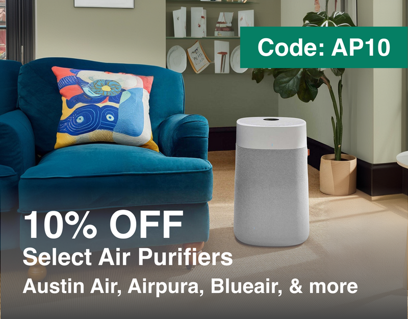 Blue armchair with a colorful pillow and a white air purifier in a room with 10%OFF Select Air Purifiers including Austin Air, Airpura, Blueair, and Rabbit Air. Code: AP10