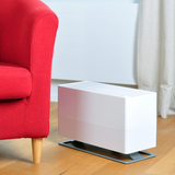 Stadler Form Oskar Big Humidifier - White - on the floor against bright red couch