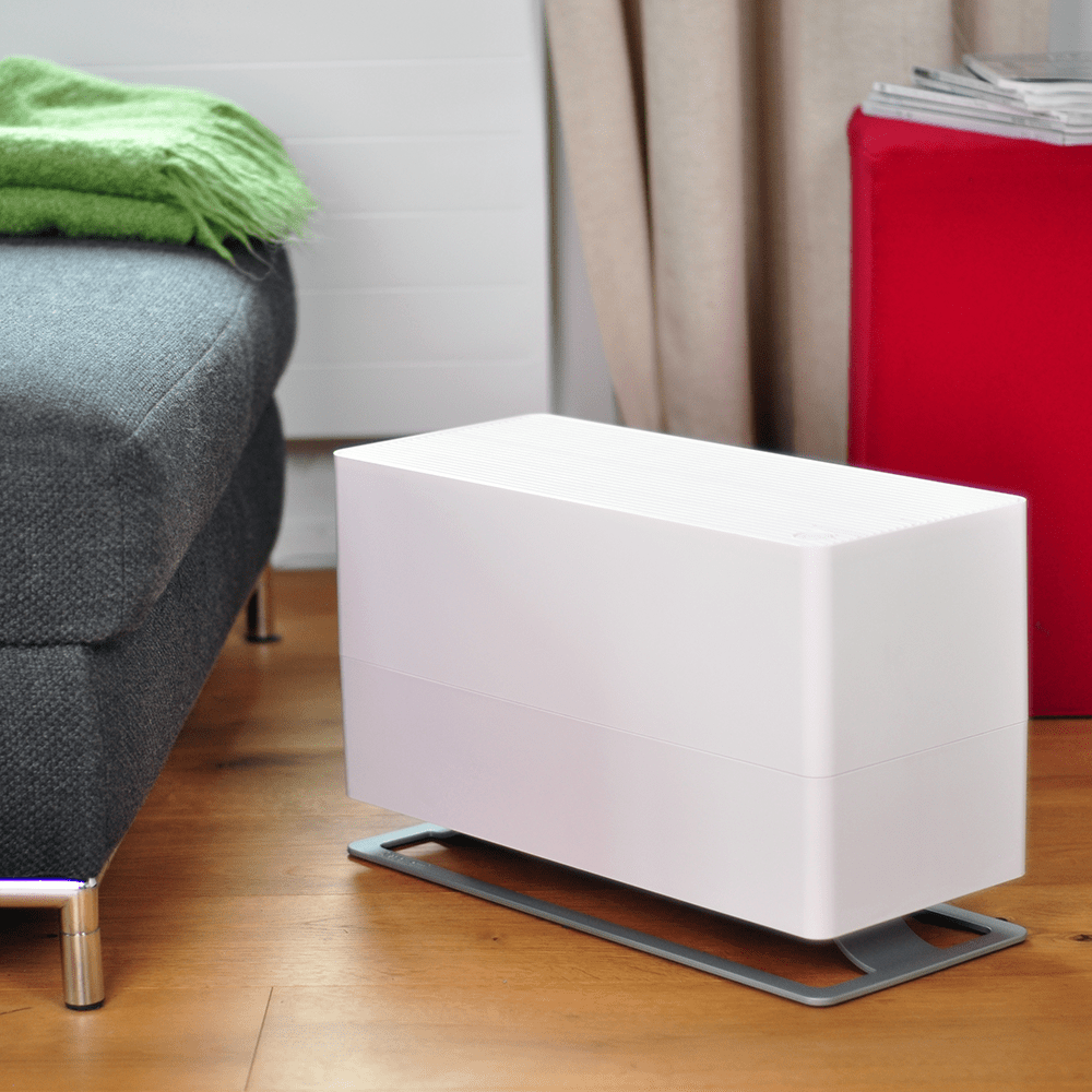 Stadler Form Oskar Big Humidifier - White - on the floor next to red couch
